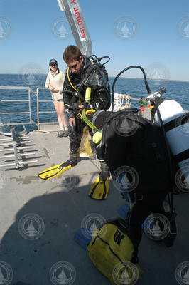 Divers preparing equipment aboard Tioga.