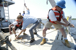 Rocky Geyer, Ken Houtler and Jay Sisson secure a line during recovery of a tripod.