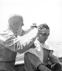 Otto Solberg cutting Captain Lane's hair on deck