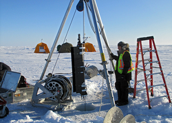 Kris Newhall standing with an ITP loaded up for deployment into the ice hole.
