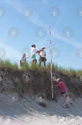 Sea Grant volunteers surveying beach profile.