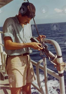 Conrad Neumann with an instrument aboard Atlantis II