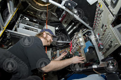 Korey Verhien working inside the Alvin personnel sphere during disassembly.