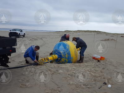 Kris Newhall, Jim Ryder and Jeff Pietro collect a right whale detection buoy.