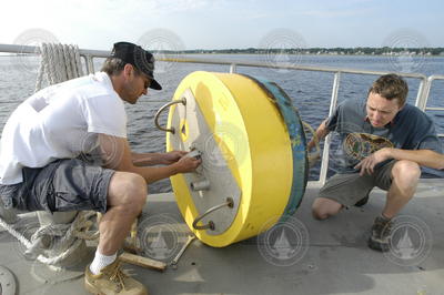 Rocky Geyer and Dave Ralston disassemble a mooring.