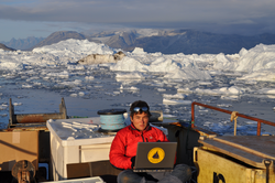Fiamma Straneo working on a laptop in Sermilik Fjord, Greenland.
