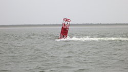7-knot current passing through a channel marker near Columbia River mouth.