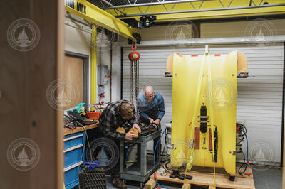 Victor Naklicki (left) and Mike Jakuba inspecting an AUV Clio battery pack.