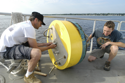 Rocky Geyer and Dave Ralston disassemble a mooring.