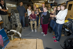 Mario Fernandez (left) showing the FHS students how to operate a manipulator arm