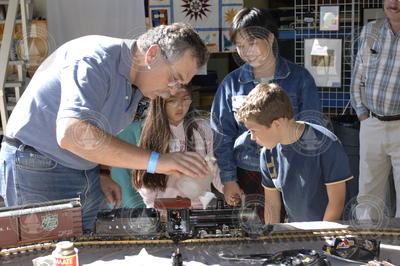 Ken Brink demonstrating his model trains as part of the arts and crafts exhibit.