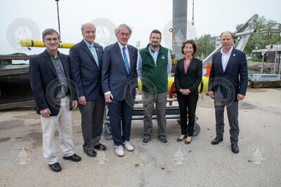 Group of government visitors and WHOI leadership. Names below.