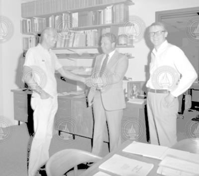 Hartley Hoskins (left), unidentified man and Art Maxwell in office.