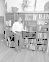 Charles Hollister standing in front of book shelves