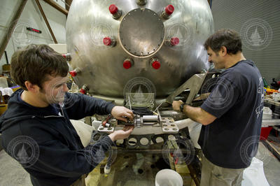 Dave Walter and Bruce Strickrott detaching the sphere during disassembly.