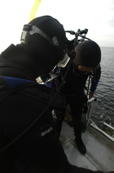Divers prepare to locate a lost instrument