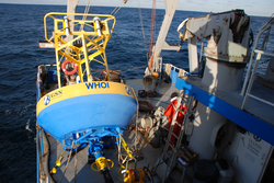 EOM buoy suspended above deck during deployment.