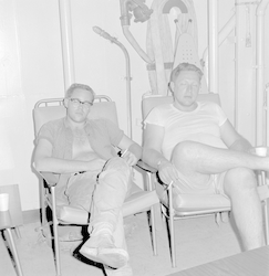 Two men sitting on deck of Chain