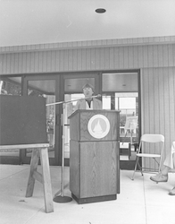 Betty Bunce at the podium outside McLean lab