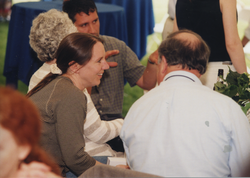 Graduate Brenda Jensen talking to a guest.