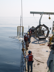 Scientists and crew preparing to recover the spar buoy.