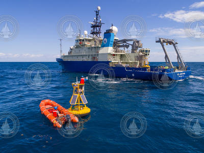 Researchers setting up PEACH sensors on a buoy just off Armstrong's port side.