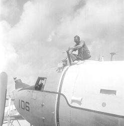 Man sitting on top of R4D aircraft