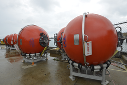 Pioneer Array mooring subsurface flotation spheres staged on the dock.