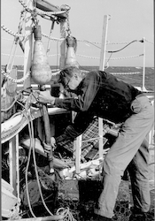 Man working on deck with instrument