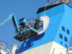 WHOI logo plate installation onto R/V Armstrong stack.
