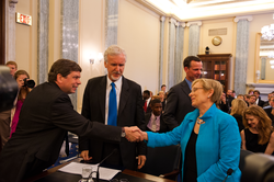 Subcommittee chair Mark Begich greeting Susan Avery.