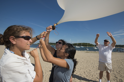 Researchers launching a weather balloon at Megansett.