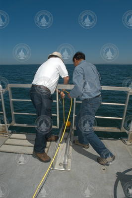 Jim Doutt and Sachin Goyal deploying sidescan sonar instrument.