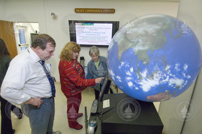 Kathy Patterson (in red) demonstrating the Magic Planet display.