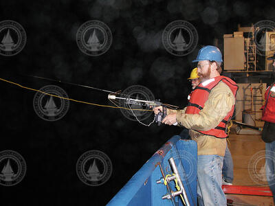 Ken Buessler and Jim Valdes using a crossbow with a grapple to recover an NBST.