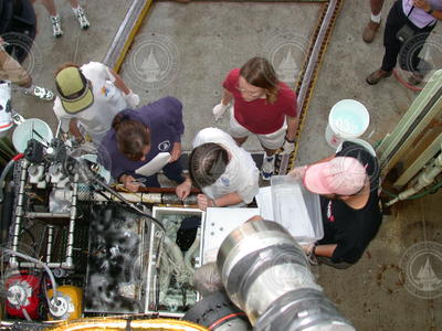 Susan Humphris and others looking into Alvin sample basket.