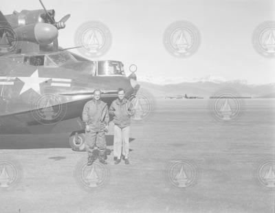 F. S. Matthews and Chuck Spooner next to PBY aircraft
