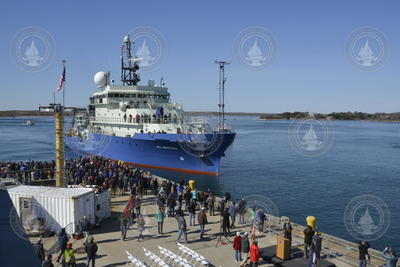Dock full of spectators welcoming R/V Neil Armstrong to its home port of WHOI.