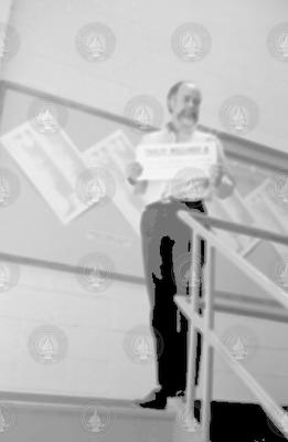 Charles Dana Densmore holding a placard