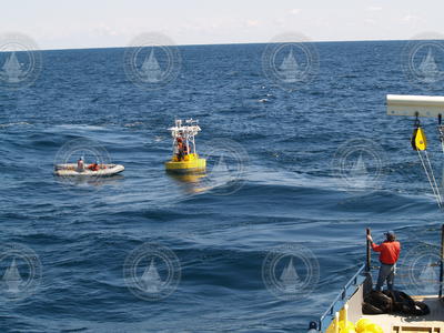 Crew in the zodiac as it heads out to repair the gulf stream buoy.