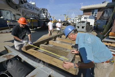 Bruce Strickrott and Rod Catanach measuring the wooden supports for Alvin.