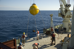 Subsurface mooring operations crew recovering a buoy.