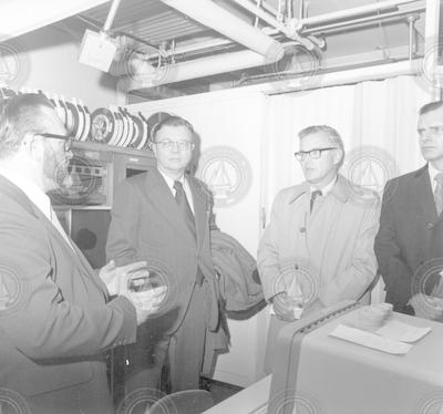 Ken Prada and three unidentified men on lab tour during Textron Inc. visit
