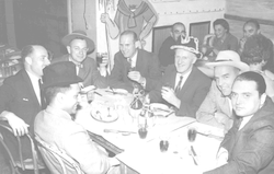 Arthur Maxwell and others having dinner.