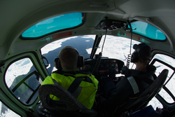 View forward from back seat of helicopter.