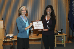 First Diane Poehls Adams award is presented to Dr. Camila Negrāo Signori.