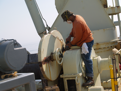 Jose Andrade, deck hand, doing preventative maintenance on a hydro winch.