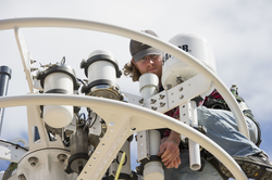Jared Schwartz installing instruments on Pioneer Array buoy.