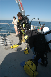 Divers preparing equipment aboard Tioga.