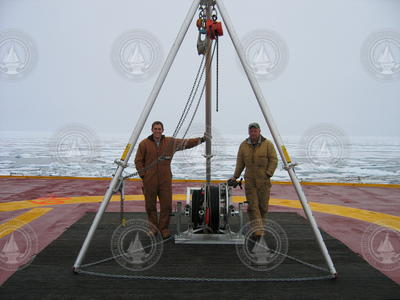 Kris Newhall and John Kemp on deck with Ice-Tethered Profiler (ITP) deployment tripod.